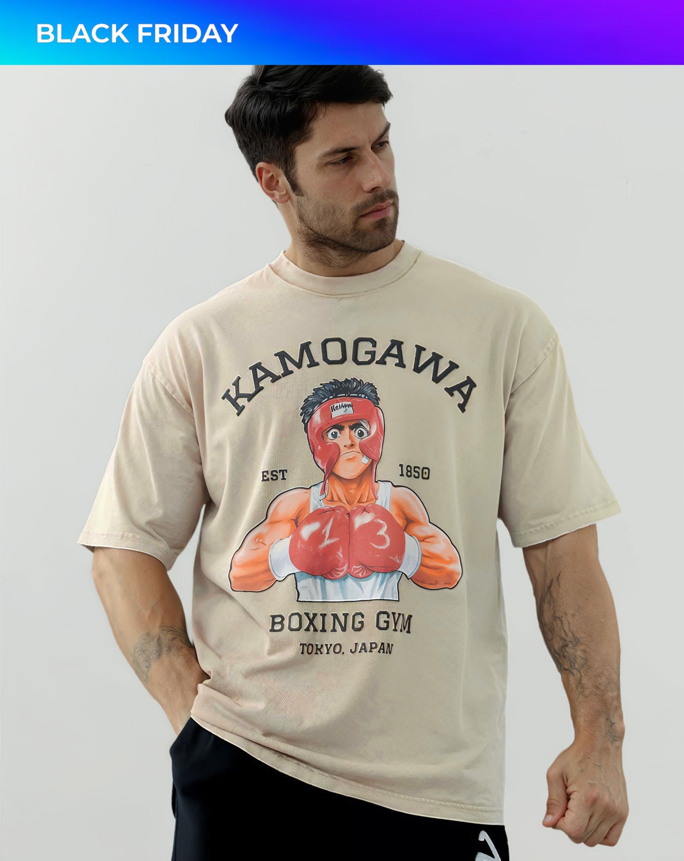 Man wearing a beige vintage washed anime-inspired streetwear t-shirt featuring a bold boxing gym graphic design, relaxed oversized fit from Torazen’s Ippo Spar Vintage Tee.