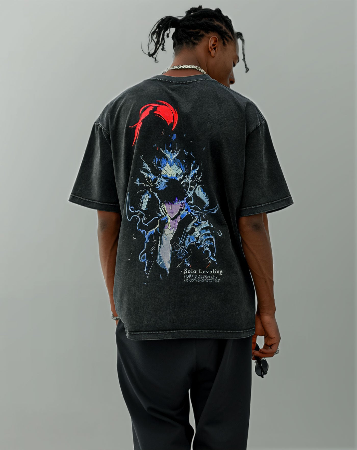 Man wearing a black vintage washed anime-inspired streetwear t-shirt with a glowing blue and red back graphic design, relaxed oversized fit from Torazen’s Power in Every Thread collection.