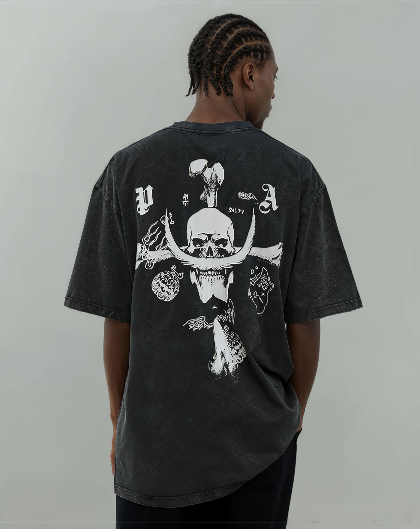 Man wearing a vintage washed black anime-inspired streetwear t-shirt featuring a bold skull and crossbone design, relaxed oversized fit from Torazen’s Whitebeard Pirates Legacy tee.