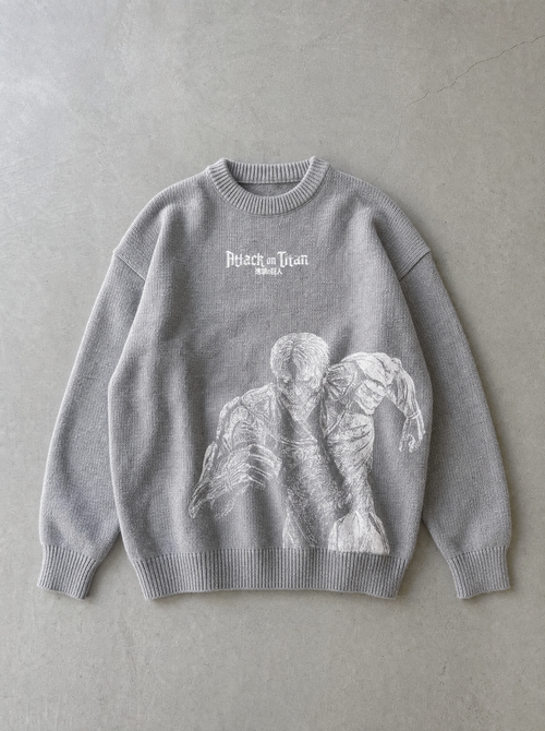 Flat lay of AOT ✦ Armoured Titan Knitted Sweater on concrete