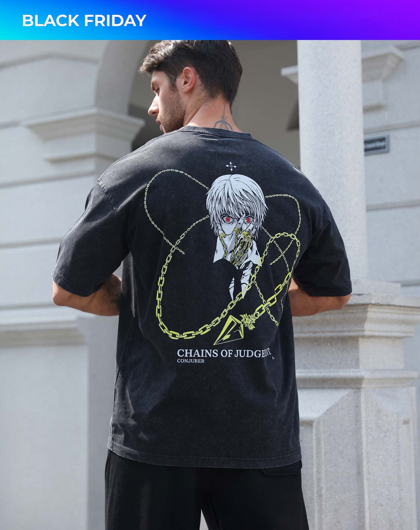 Man wearing a black vintage washed anime-inspired streetwear t-shirt featuring a silver-haired character with gold chain graphics on the back, relaxed oversized fit from Torazen’s Chains of Judgment tee.